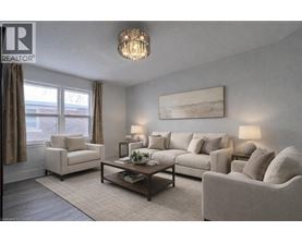 A living room with a large couch, a chair, and a coffee table.
