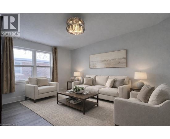A living room with a large couch, a chair, and a coffee table.