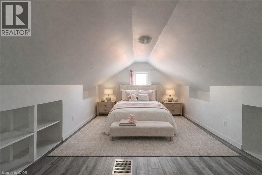 A bedroom with a large bed and a window.