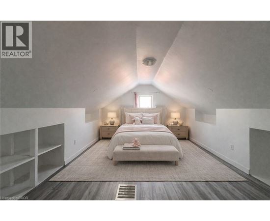 A bedroom with a large bed and a window.