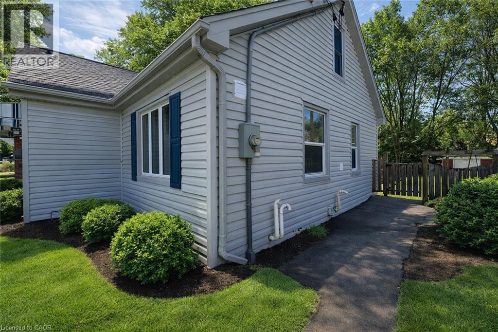 A house with a white siding and a green window trim.