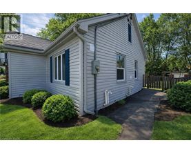 A house with a white siding and a green window trim.