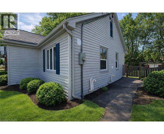 A house with a white siding and a green window trim.
