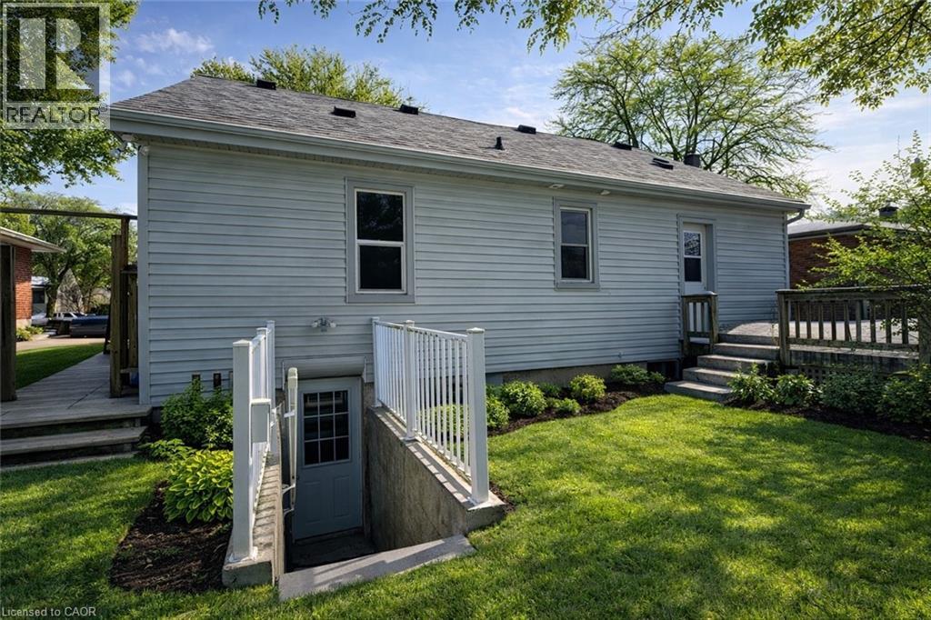 A white house with a grey roof and a small front porch.
