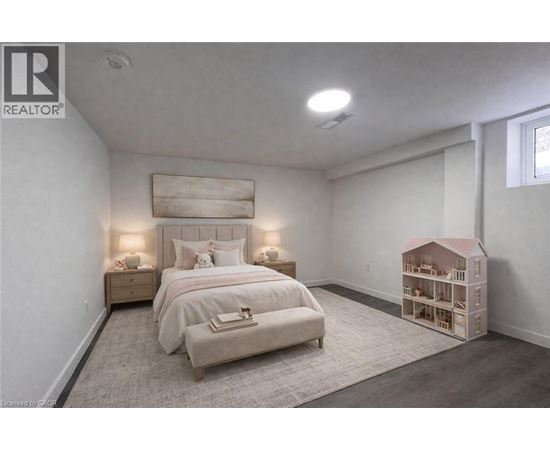 A bedroom with a bed, nightstands, and a dollhouse.