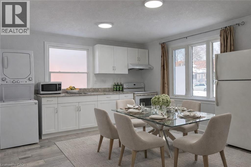 A modern kitchen with a dining table set for two.
