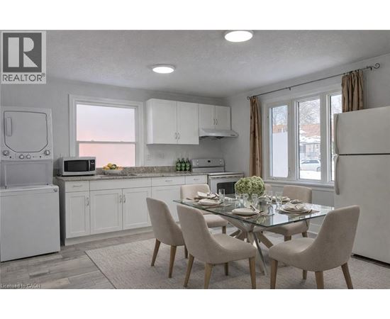 A modern kitchen with a dining table set for two.