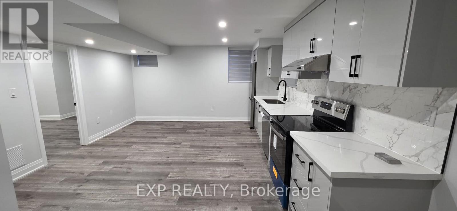 A kitchen with a marble countertop and a tiled floor.