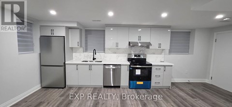 A modern kitchen with white cabinets and a blue dishwasher.