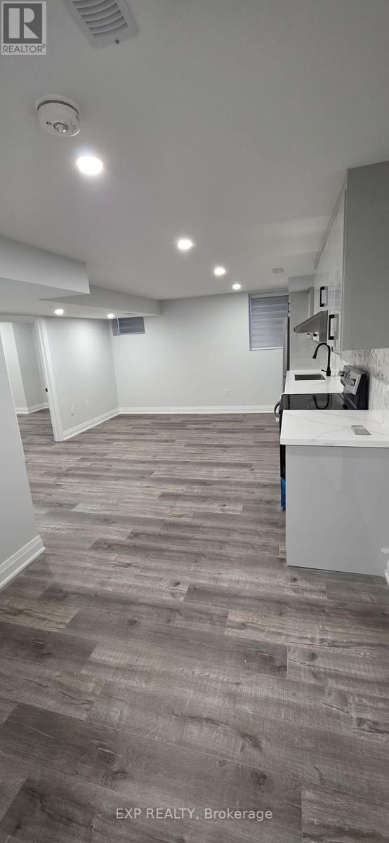 A room with a grey carpet and white walls.