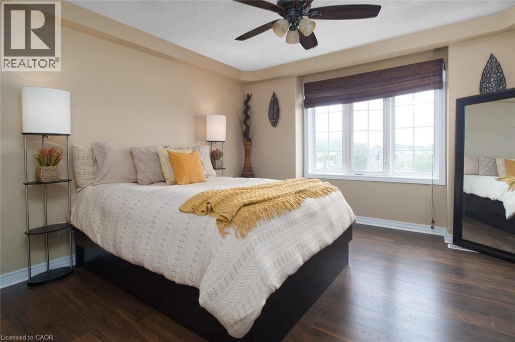A bedroom with a large bed and a ceiling fan.