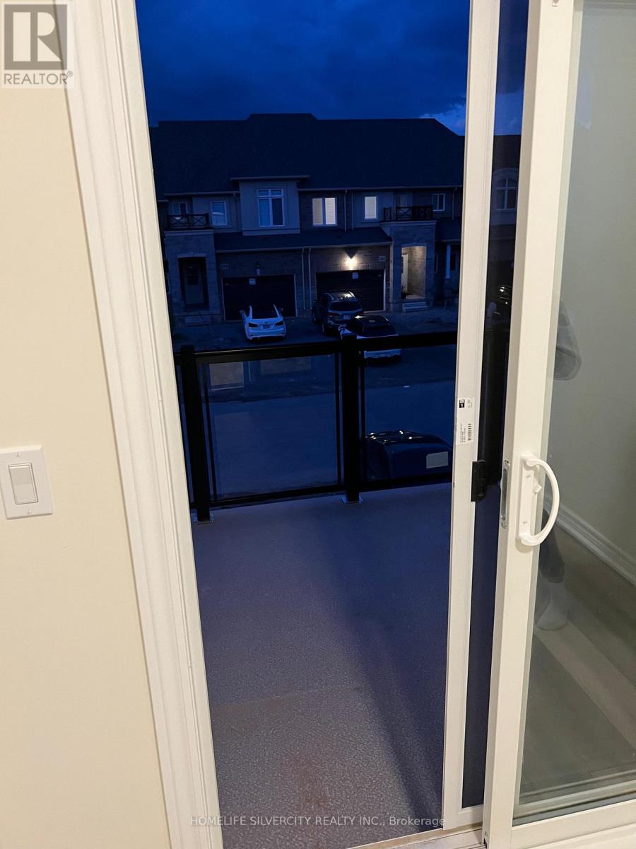 A glass door with a handle is open to a balcony.