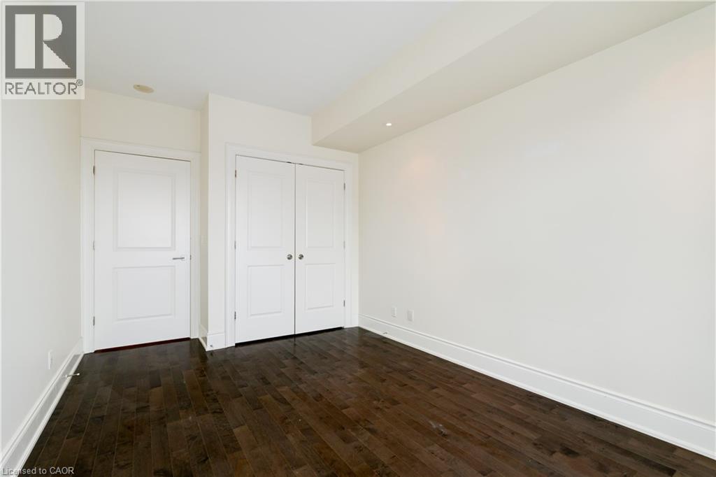 A spacious living room with a fireplace and hardwood floors.