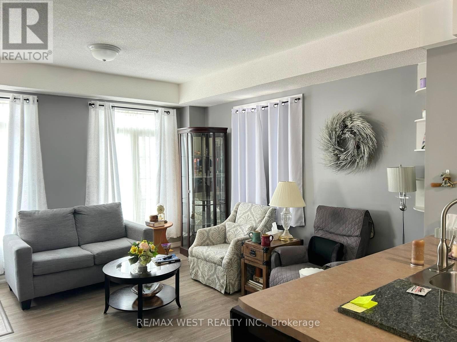 A living room with a grey couch, a chair, and a coffee table.