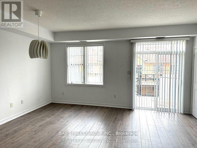 A room with a sliding glass door leading to a balcony.