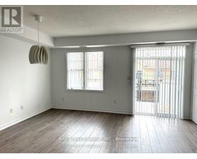 A room with a sliding glass door leading to a balcony.