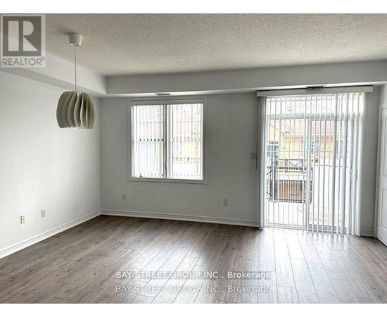 A room with a sliding glass door leading to a balcony.