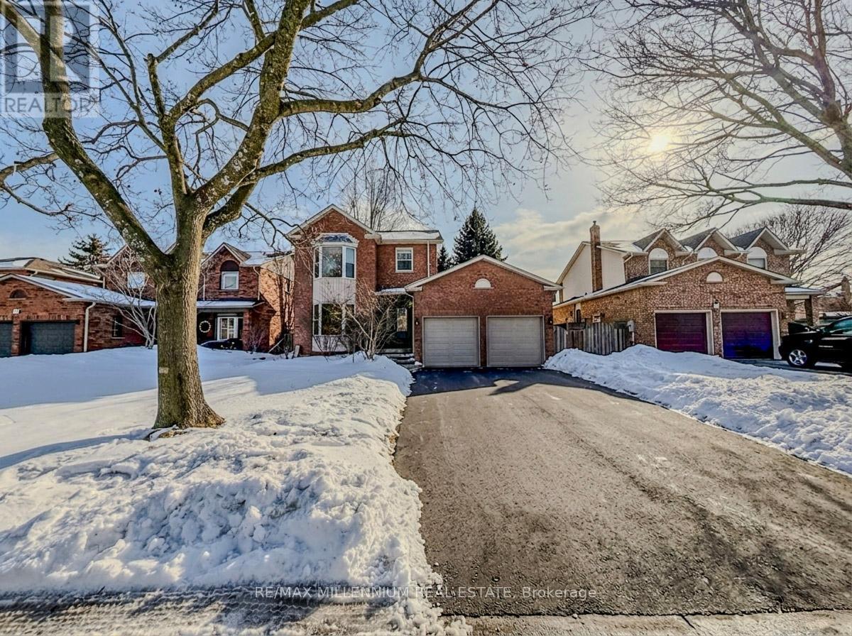 A house with a driveway and snow on the ground.