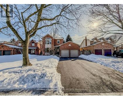 A house with a driveway and snow on the ground.