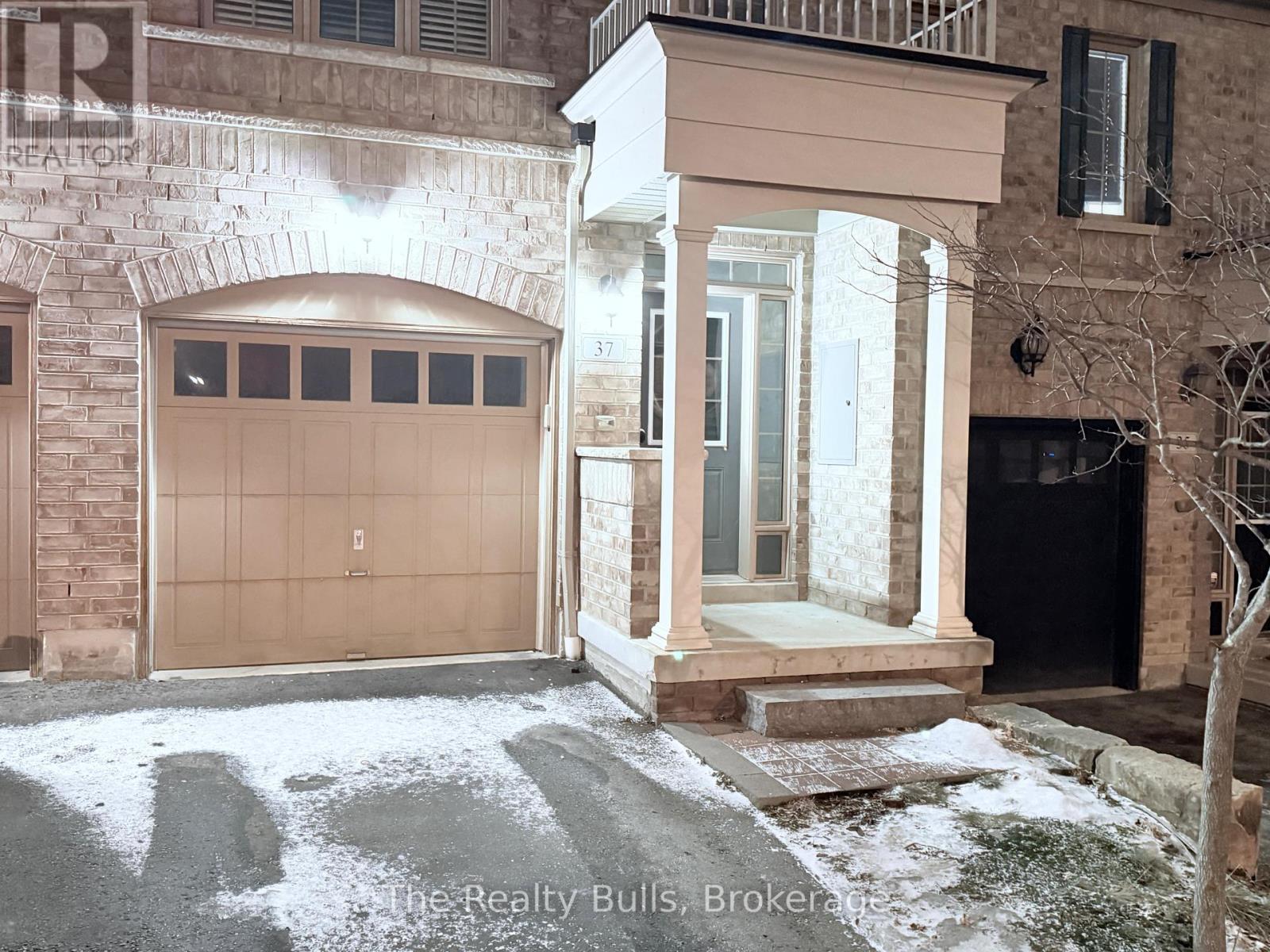 A building with a brown garage door and a white entrance.