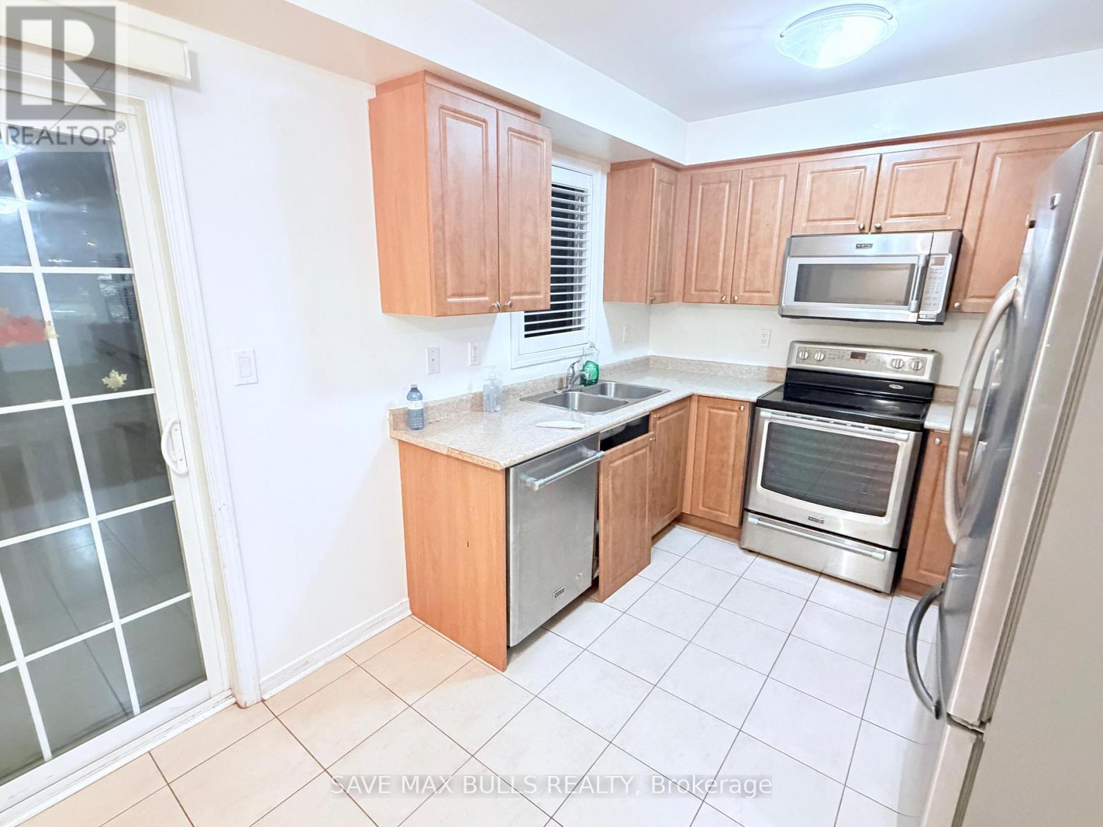 A kitchen with wooden cabinets and stainless steel appliances.
