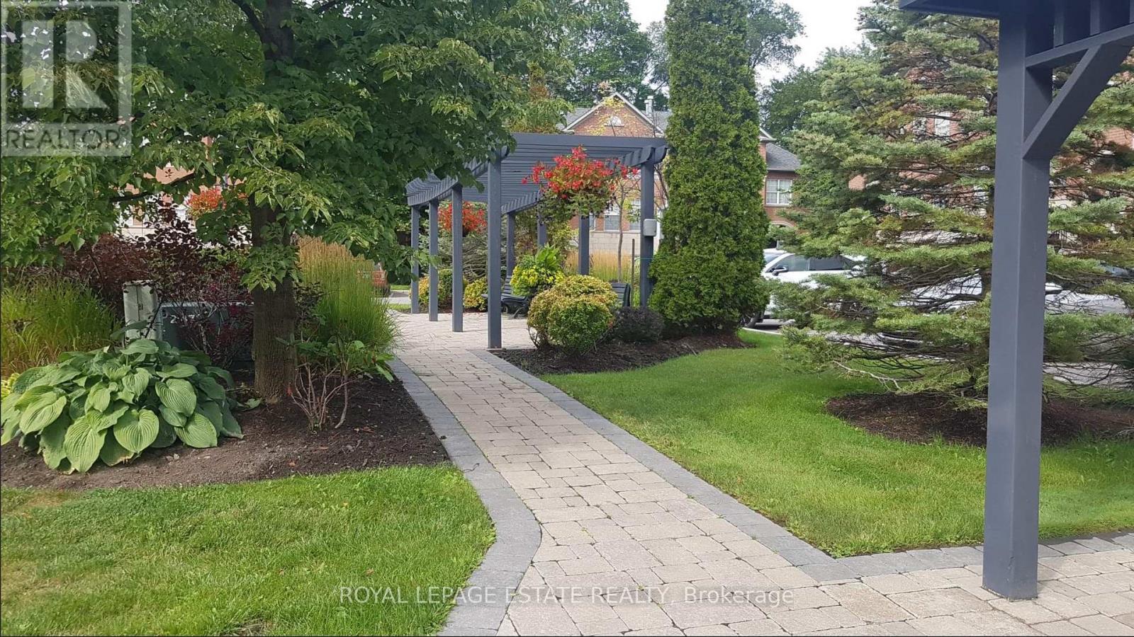 A walkway with a sign that says Royal LePage Estate Realty Brokerage.