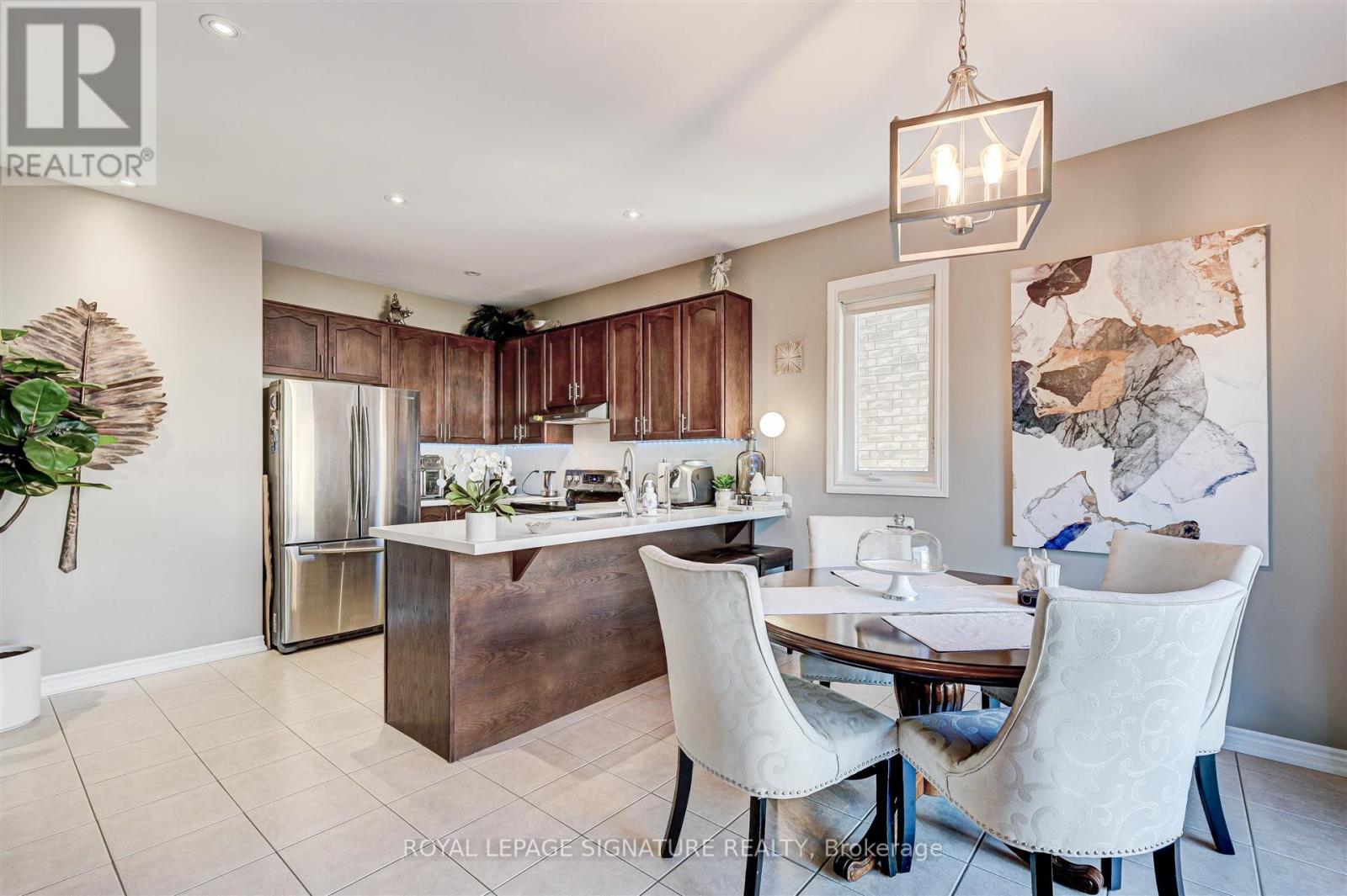 A modern kitchen with a dining table set up.