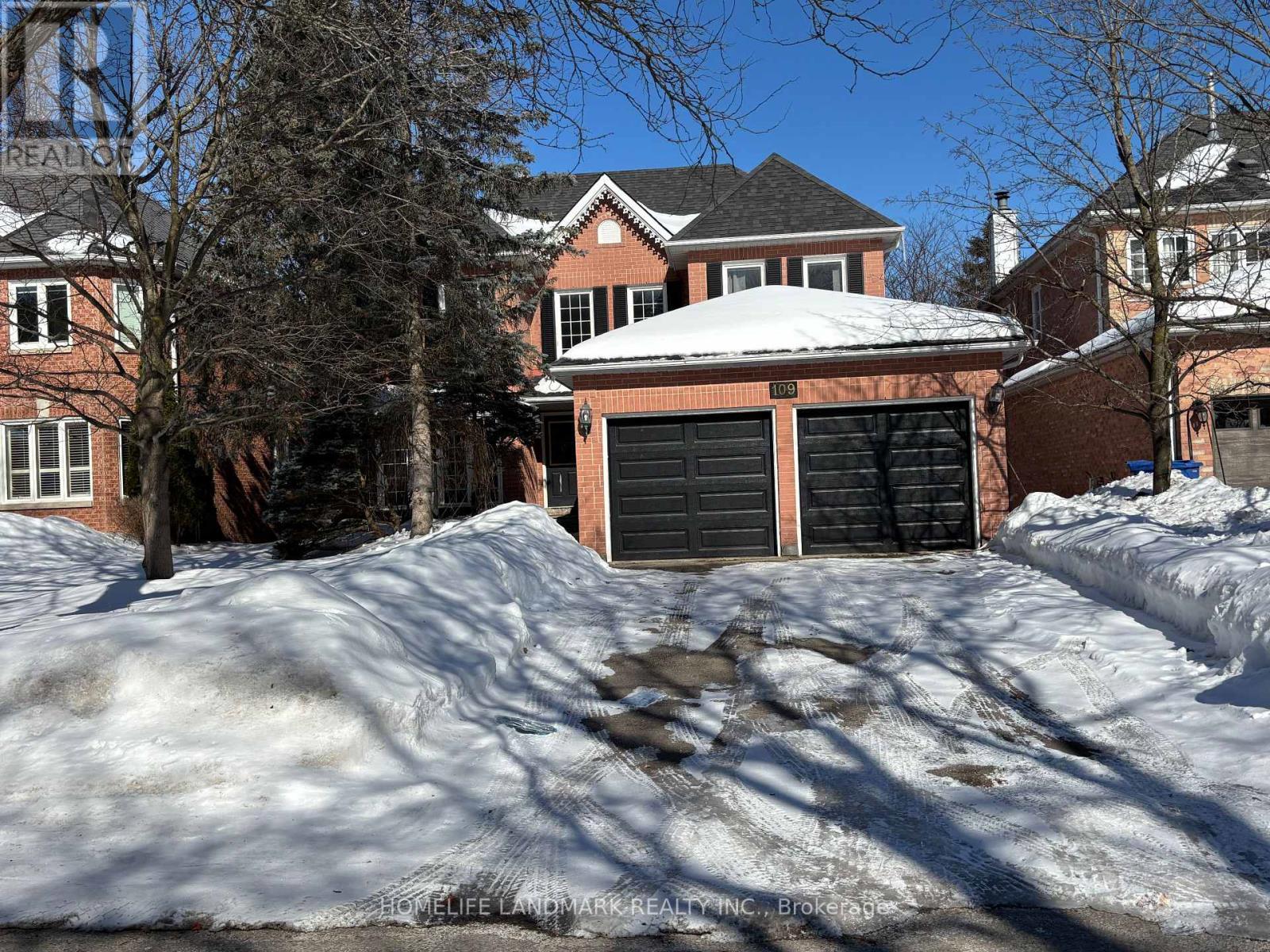 A house with a snow-covered roof and a garage door.