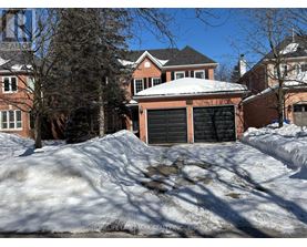 A house with a snow-covered roof and a garage door.