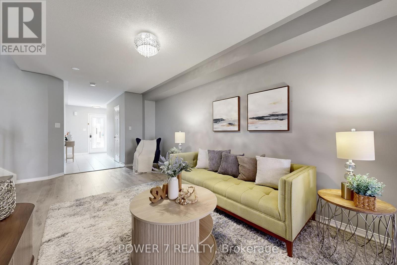 A living room with a yellow couch and a coffee table.