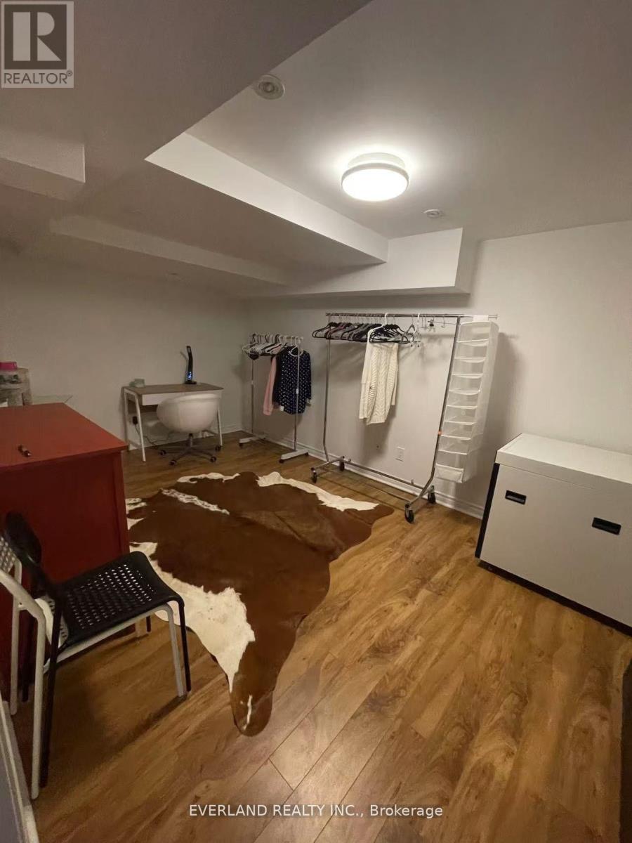 A room with a cowhide rug and a chair.