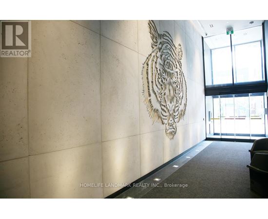A tiger head sculpture is mounted on a wall in a hallway.