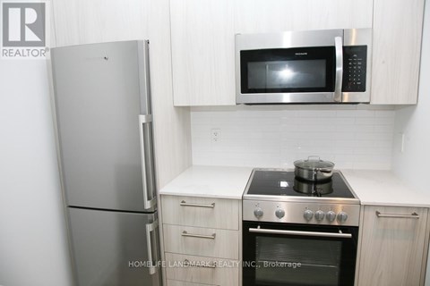 A kitchen with a stove, oven, refrigerator and microwave.