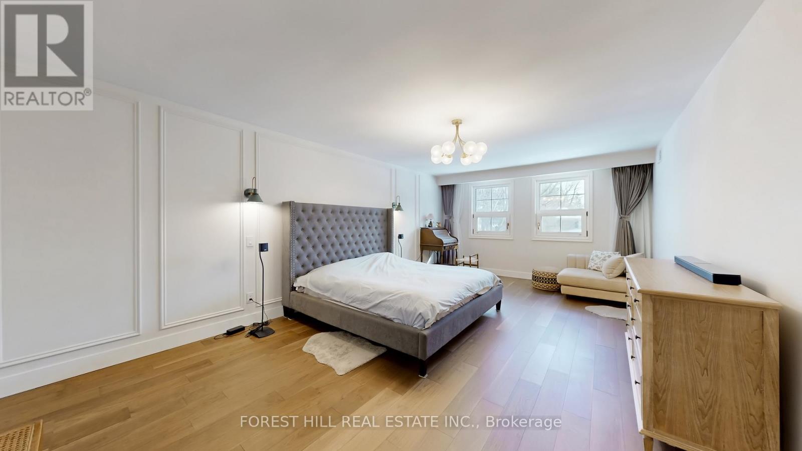A bedroom with a bed, nightstand, and lamp.