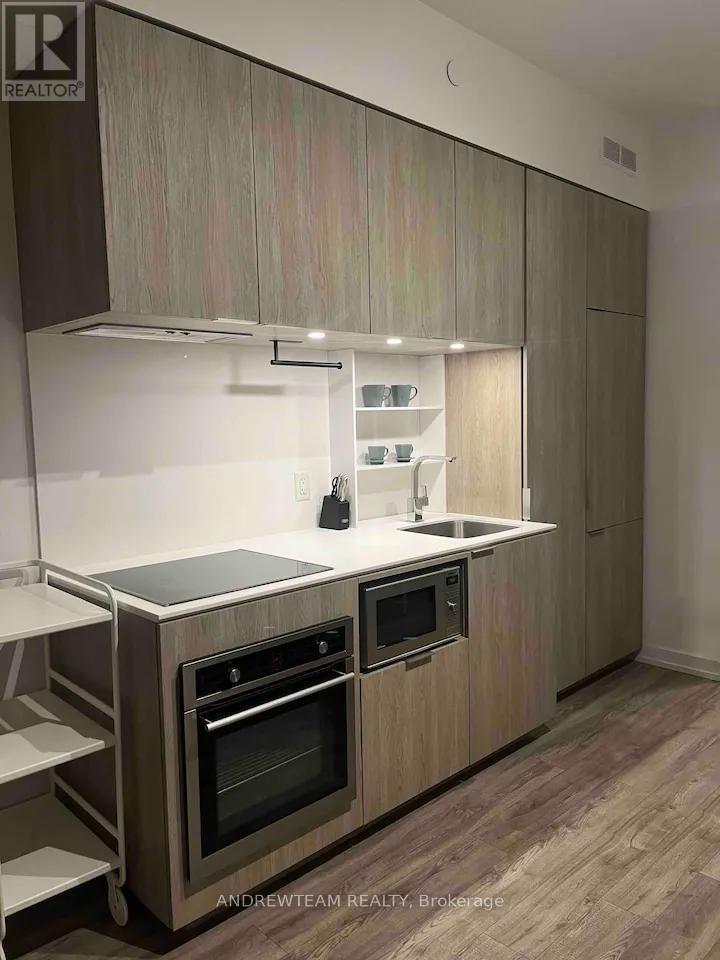 A modern kitchen with wooden cabinets and stainless steel appliances.