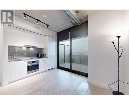A modern kitchen with white cabinets and stainless steel appliances.