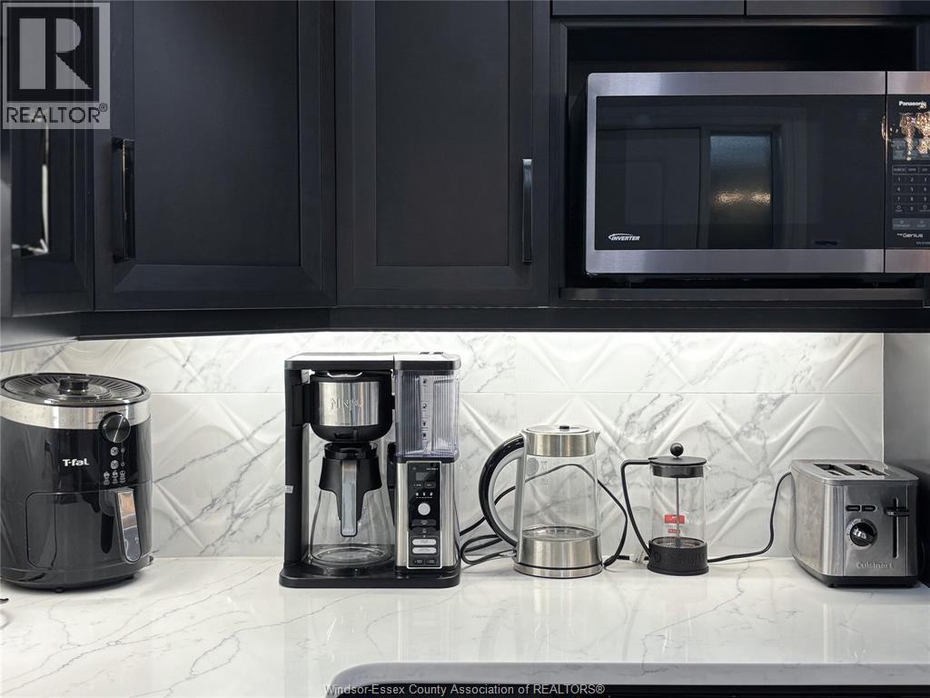 A kitchen counter with a coffee maker, a toaster, and a microwave.