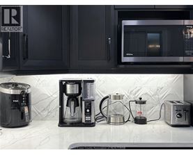A kitchen counter with a coffee maker, a toaster, and a microwave.
