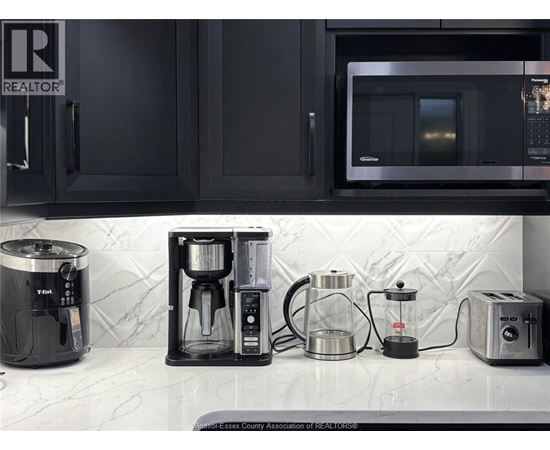A kitchen counter with a coffee maker, a toaster, and a microwave.