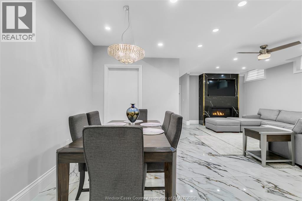 A modern dining room with a wooden table and grey chairs.