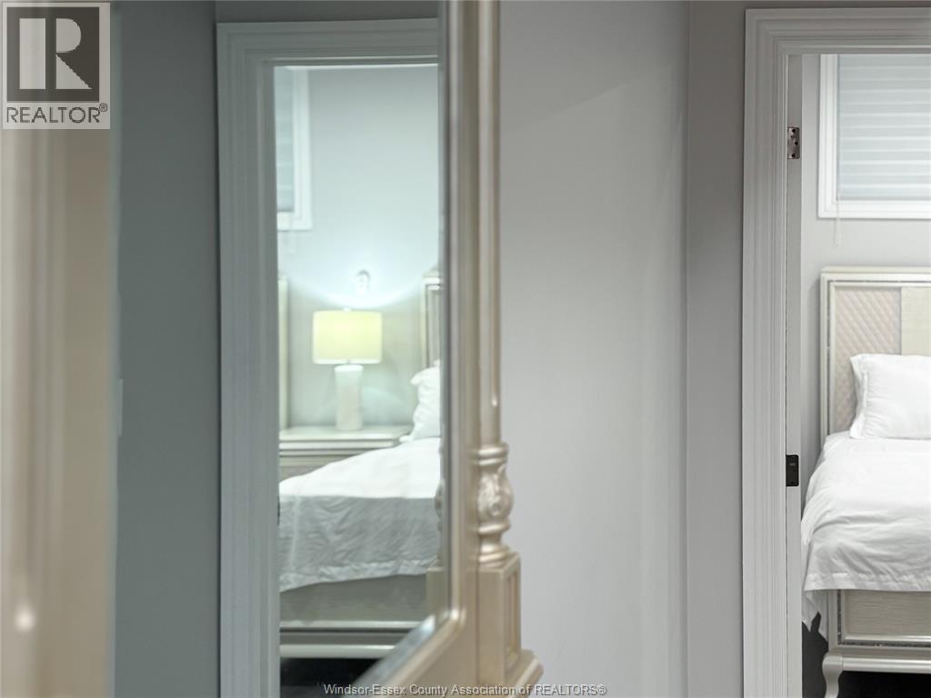 A bedroom with a bed and a lamp.