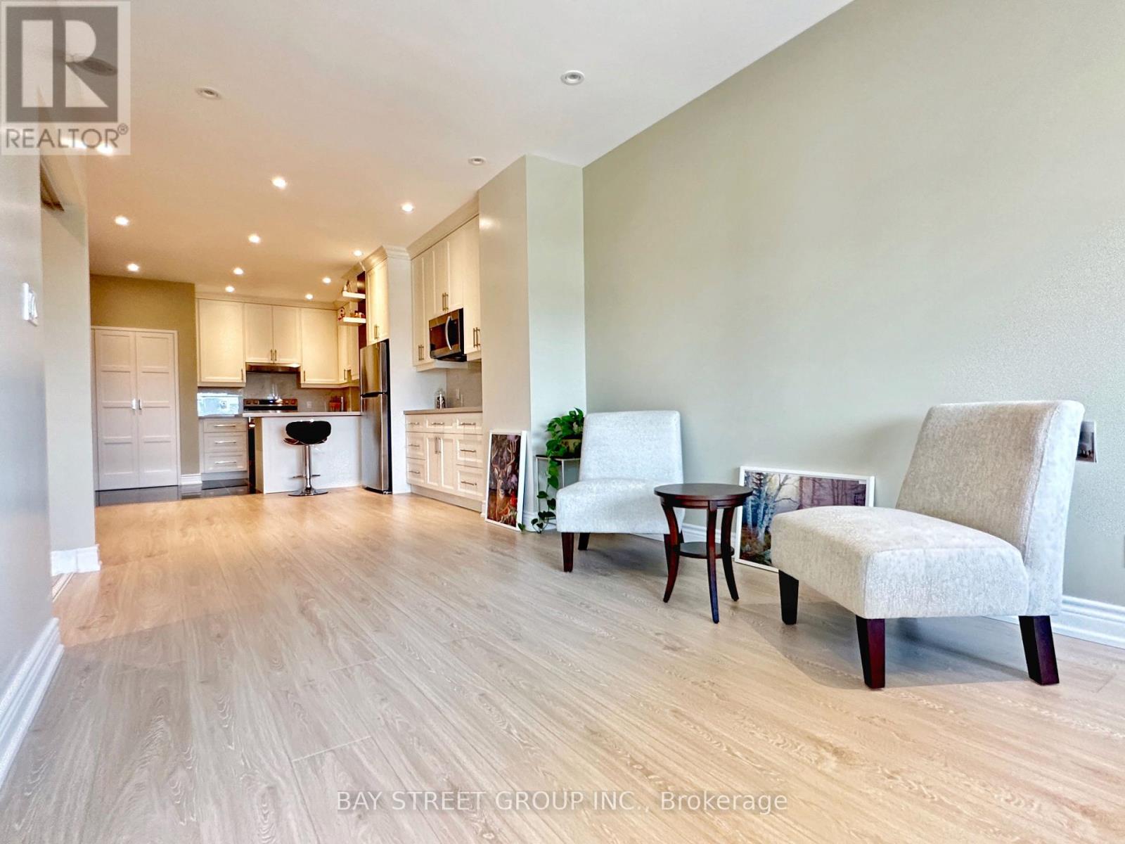 A living room with a couch, chair, and table.