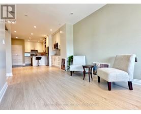 A living room with a couch, chair, and table.