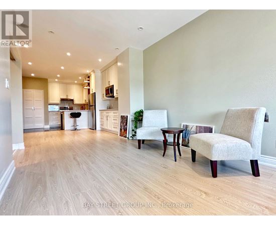 A living room with a couch, chair, and table.