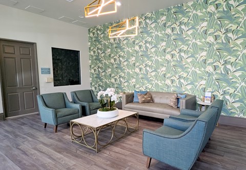 A living room with a grey sofa, two chairs and a coffee table.