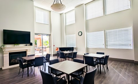A conference room with a fireplace and a television.