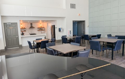 A modern dining area with a glass table and chairs.