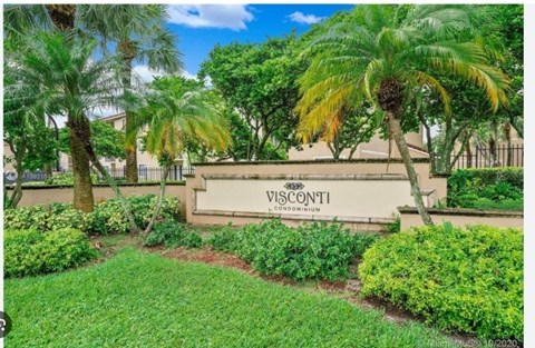 A sign that says Visconti in front of some trees.