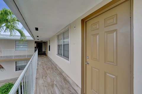 A balcony with a railing and a door.