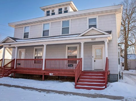 A two-story house with a red front porch.